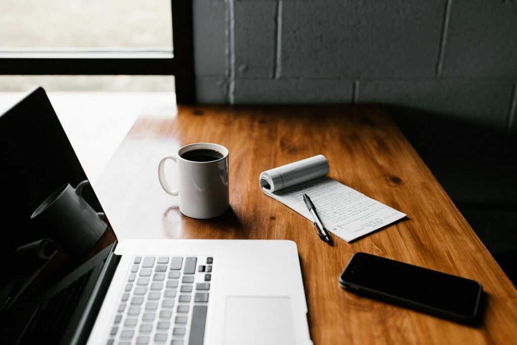 notes and pencil next to a laptop keyboard for AI budget trip planning