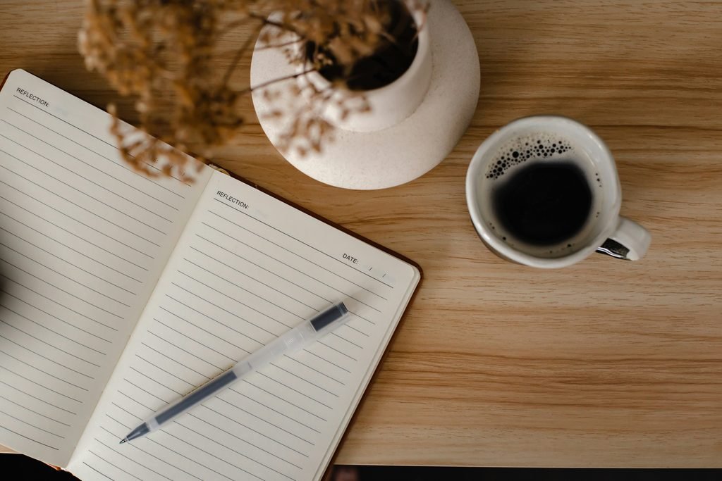 Person writing diary in the morning