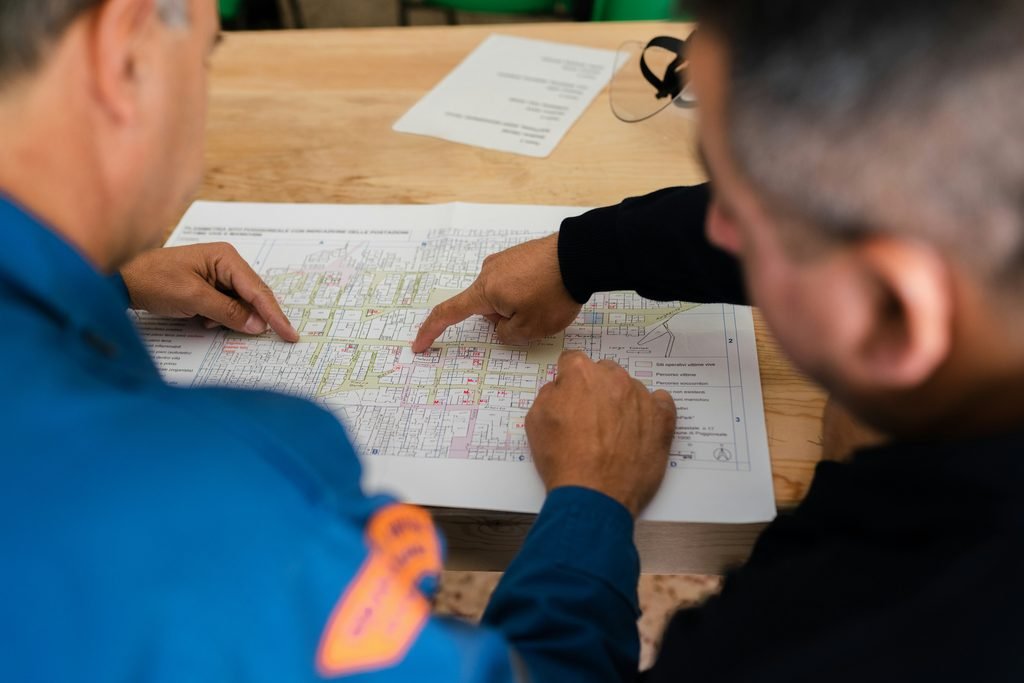 Contractor reviewing blueprint discussion